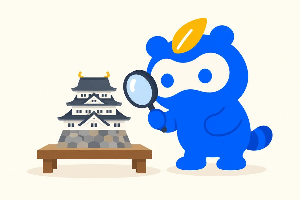 日本の城を模した模型を虫眼鏡で調べるソクポンのマスコット。